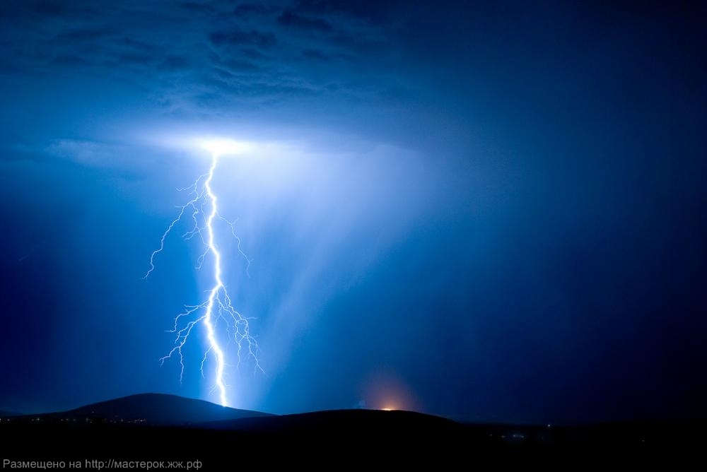 Two separate lightning bolts converge over Table Mountain in Cape Town, South Africa, with an amazing display of natural electricity.