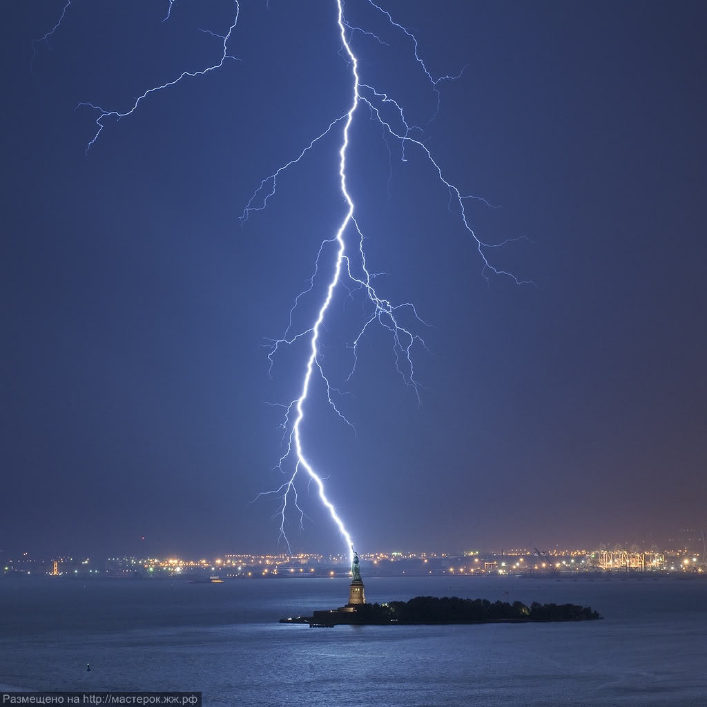 Two separate lightning bolts converge over Table Mountain in Cape Town, South Africa, with an amazing display of natural electricity.