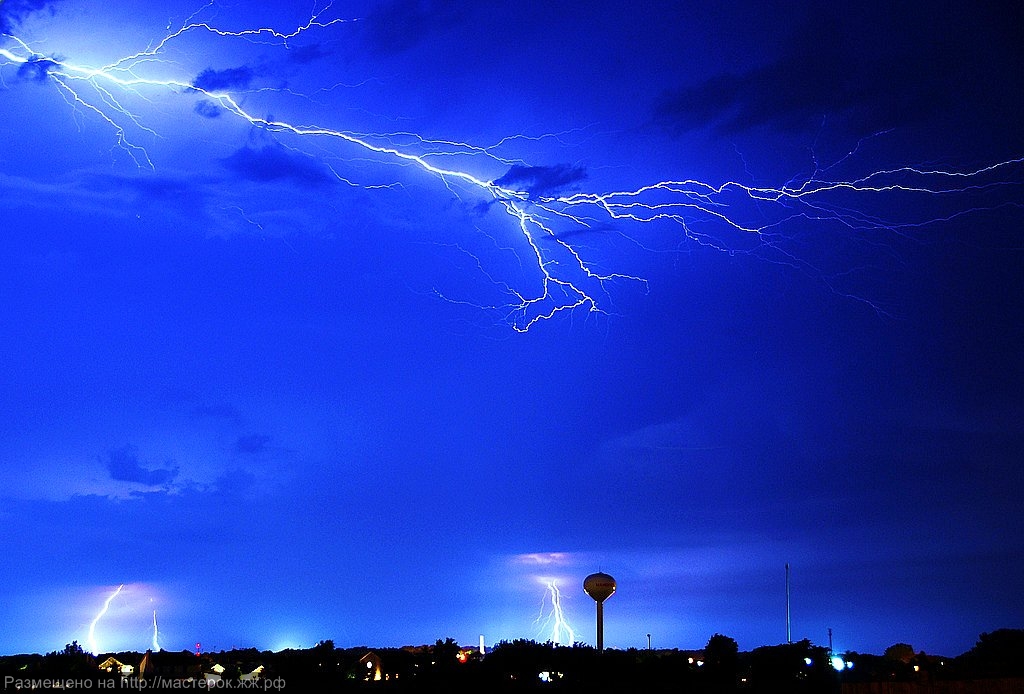 Two separate lightning bolts converge over Table Mountain in Cape Town, South Africa, with an amazing display of natural electricity.