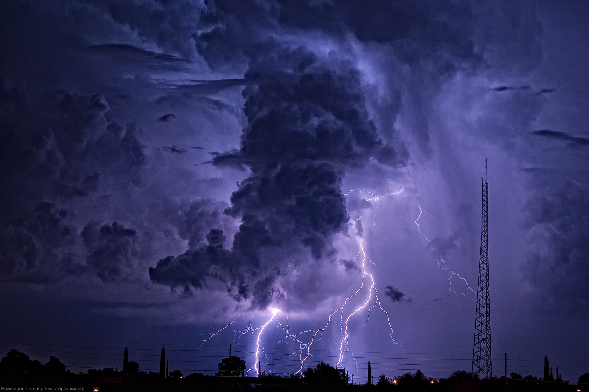 Two separate lightning bolts converge over Table Mountain in Cape Town, South Africa, with an amazing display of natural electricity.