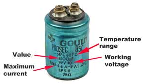Leaded aluminium electrolytic capacitor showing the key parameters marked on the case including maximum ripple current.